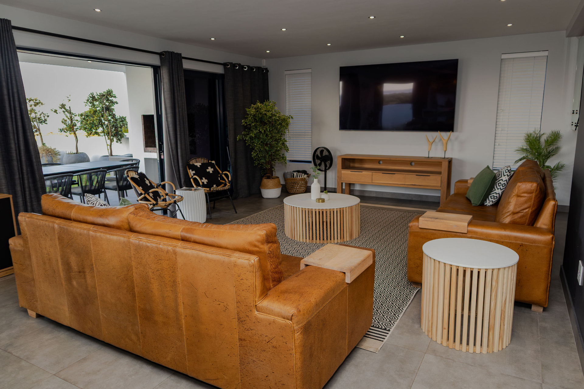 Second living room with leather couches and smart TV