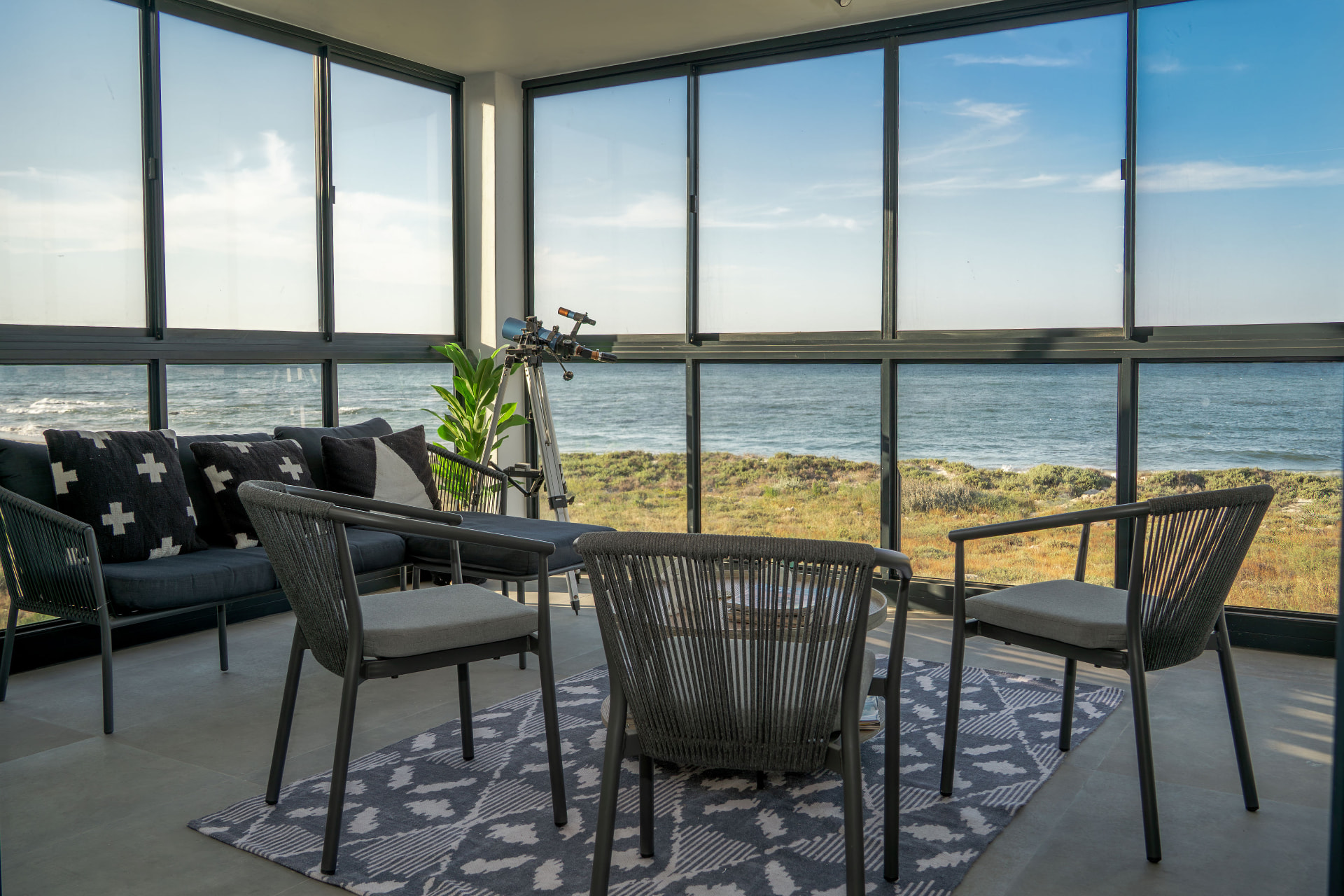 Glassed sea-facing balcony lounge with telescope