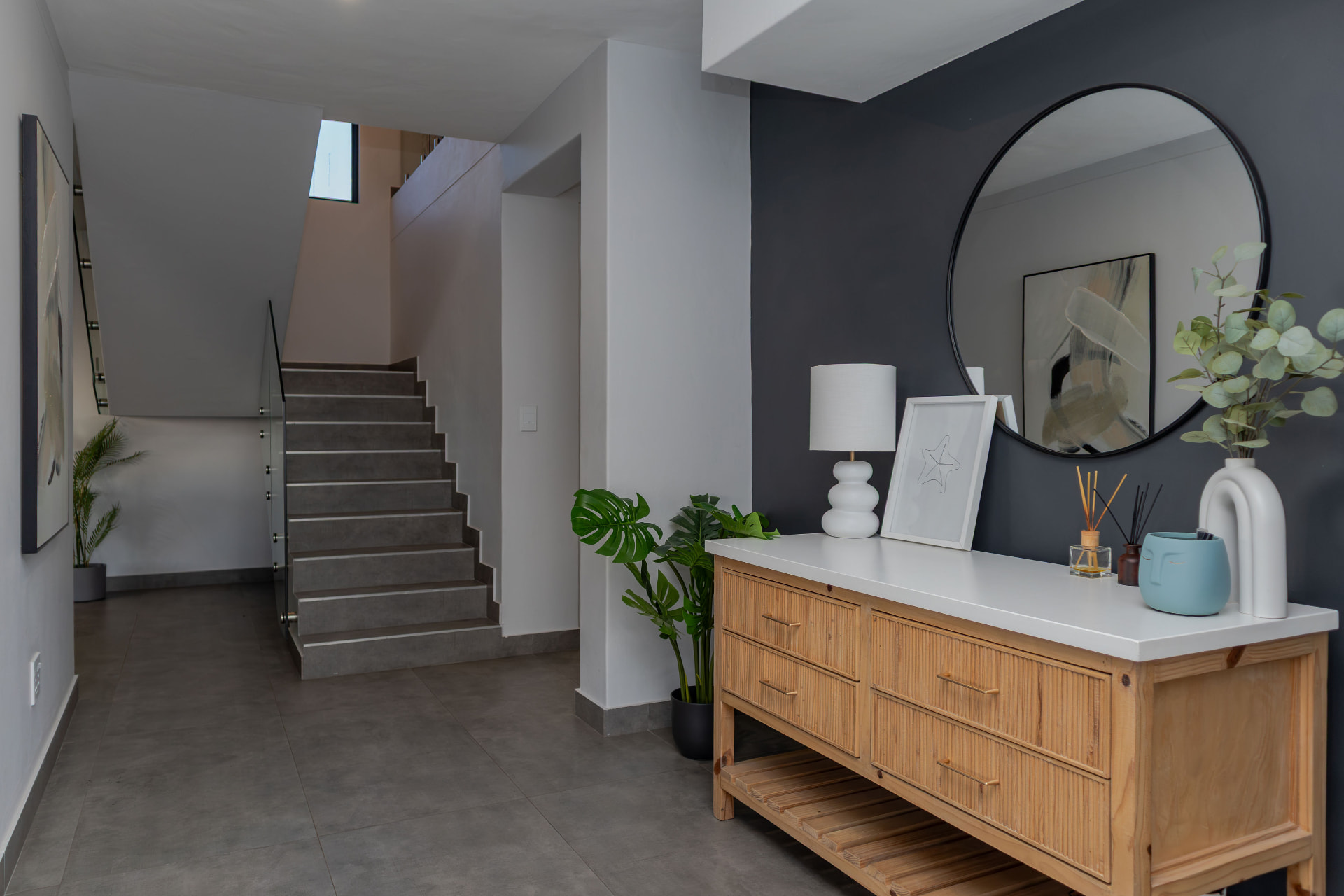 Entrance hall with staircase, mirror and starfish artwork
