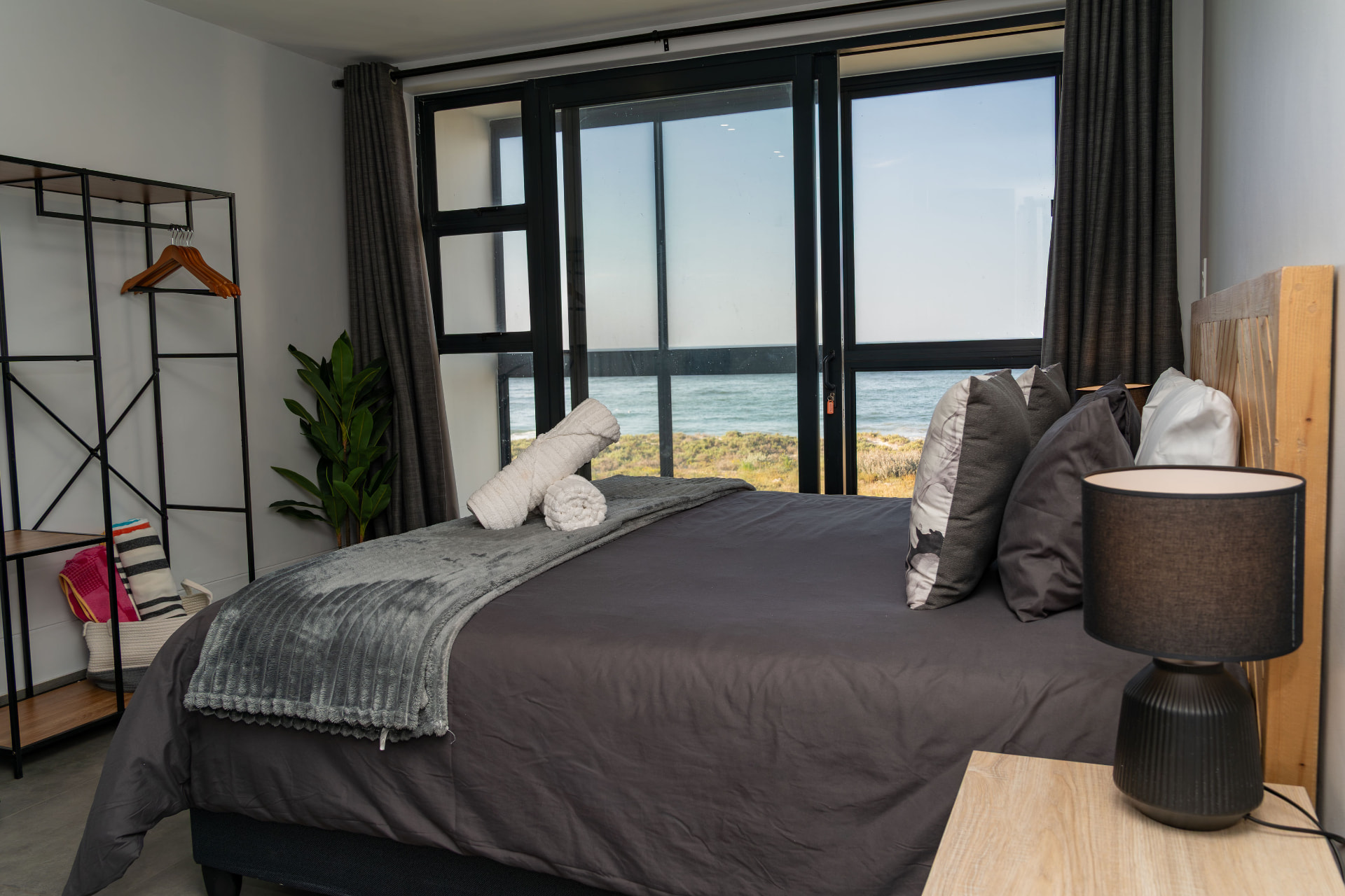 Second bedroom with full-height windows over the beach