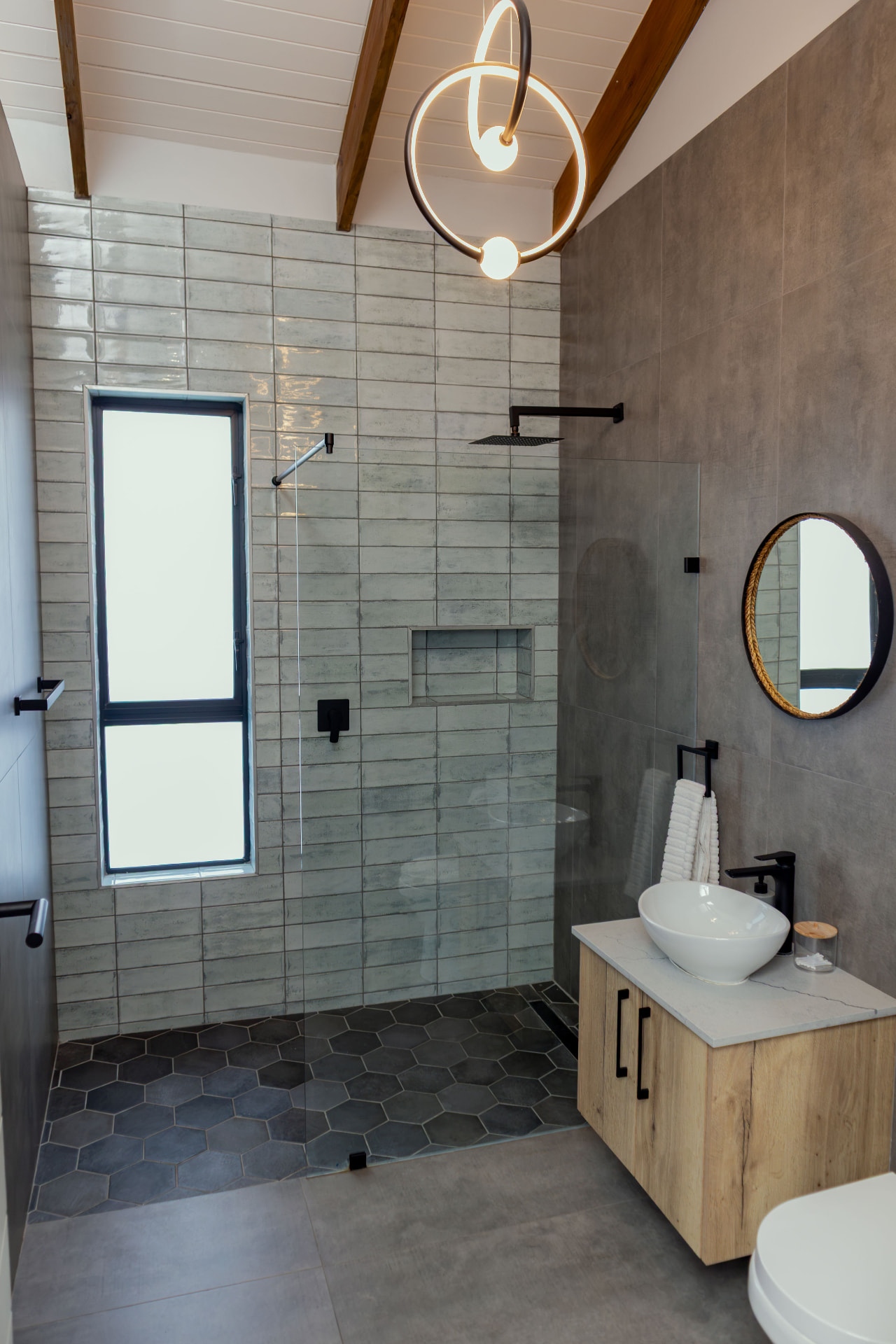 Bathroom with walk-in rain shower and stone finishes