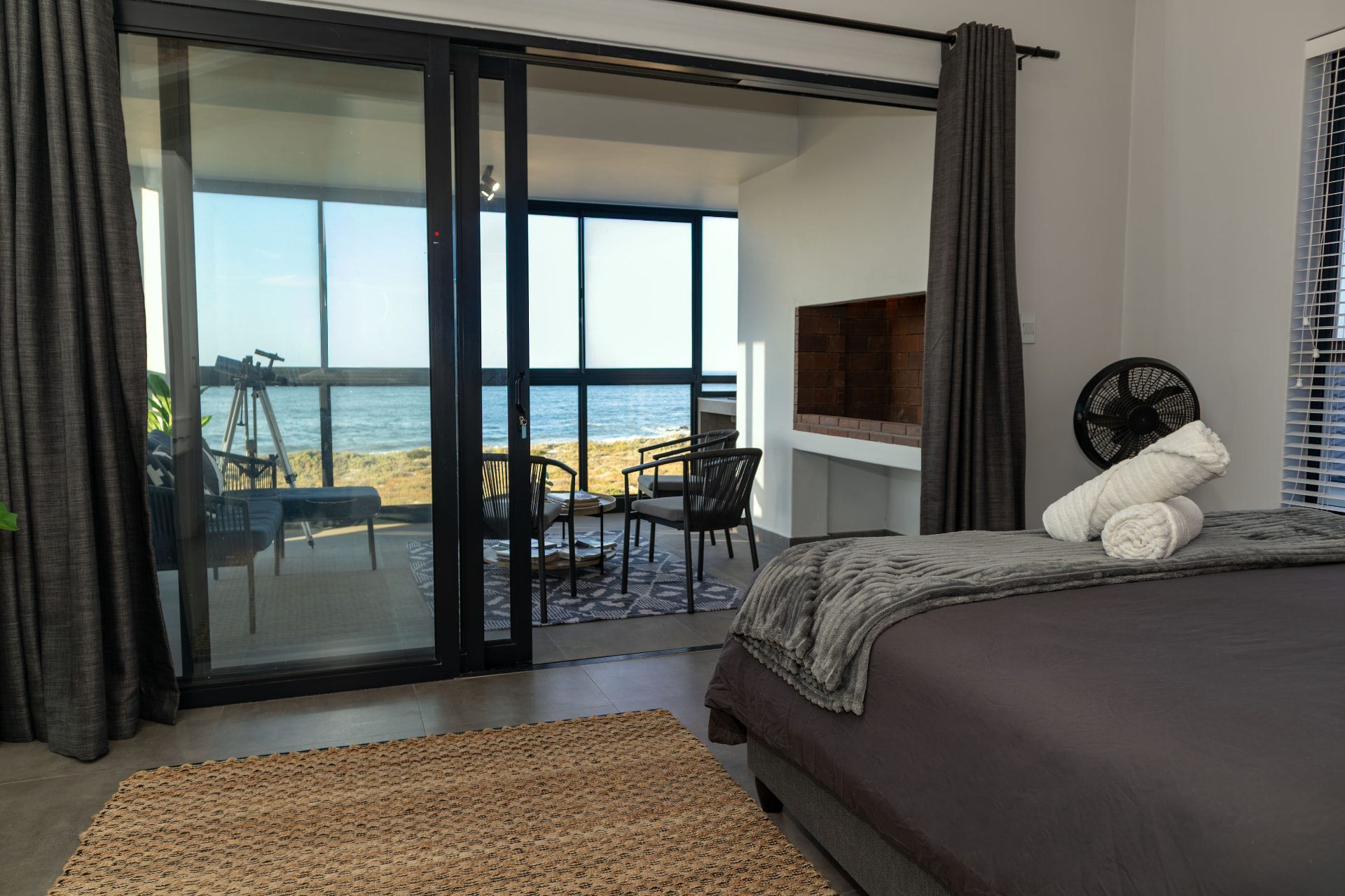 Main bedroom opening onto the balcony above the ocean